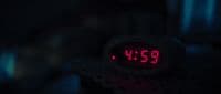 a close up of a clock in the dark