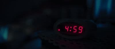 a close up of a clock in the dark