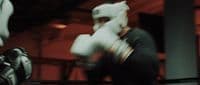 a close up of a person wearing boxing gloves