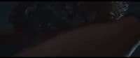 the back of a woman's head in a dark room