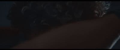 the back of a woman's head in a dark room