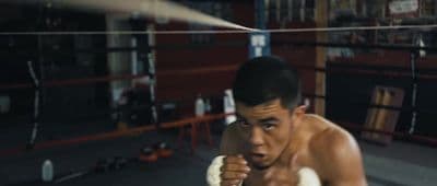 a man in a boxing ring with a punching glove