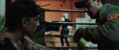 a man in a green jacket and a woman in a black top