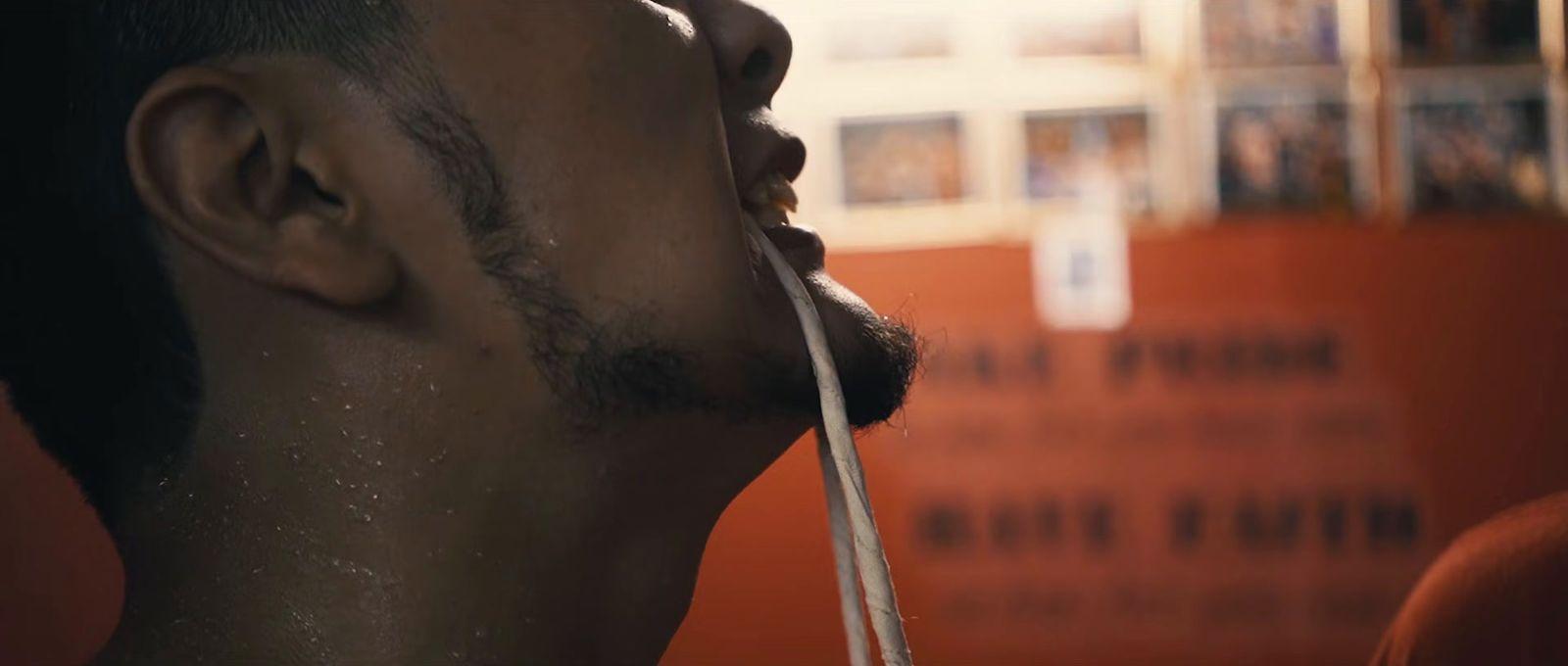 a close up of a man with a toothbrush in his mouth