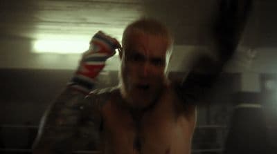 a man with no shirt on in a boxing ring