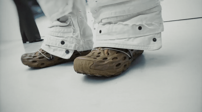 a person wearing a pair of shoes standing on a floor