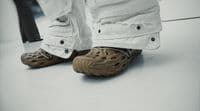 a person wearing a pair of shoes standing on a floor