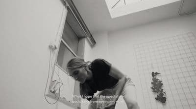 a woman bending over in a bath room