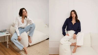 a woman sitting on a white couch next to another woman sitting on a white couch