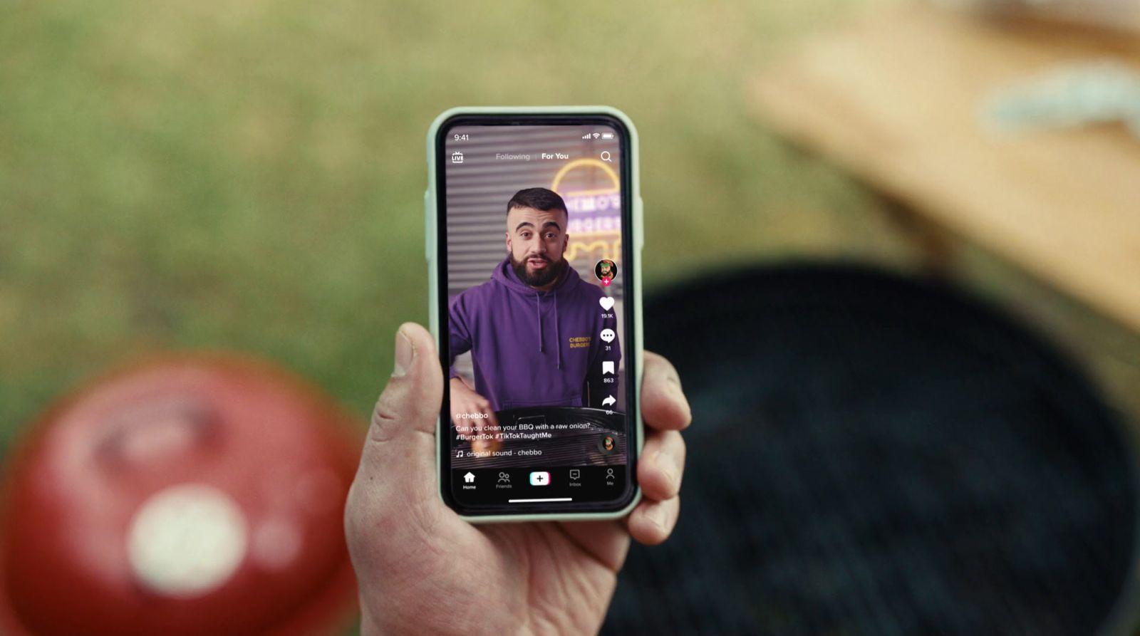 a person holding a cell phone with a picture of a man on it