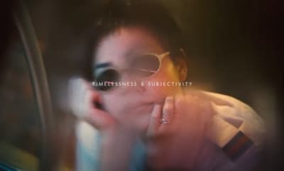 a woman wearing sunglasses is talking on a cell phone