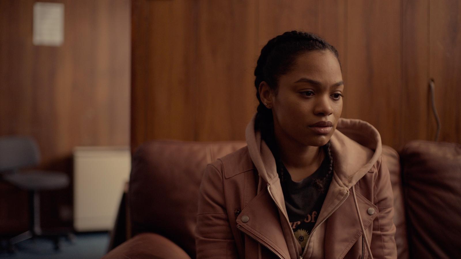 a woman sitting on a couch in a room
