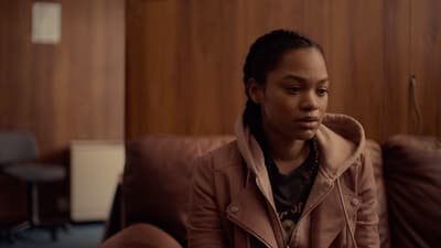 a woman sitting on a couch in a room