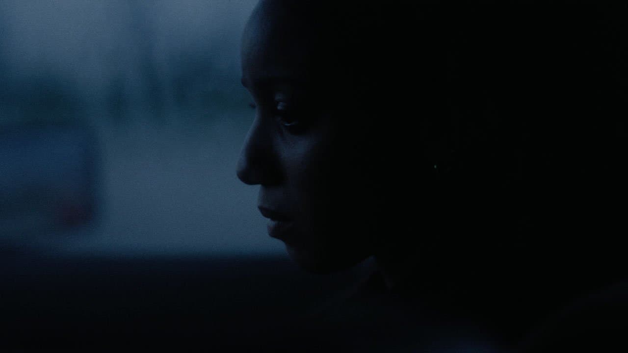 a woman in a dark room staring at something