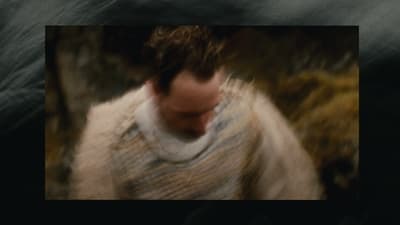 a blurry photo of a man wearing a sweater