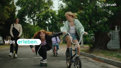 a group of women riding bikes down a street