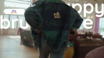 the back of a person wearing a jacket with writing on it