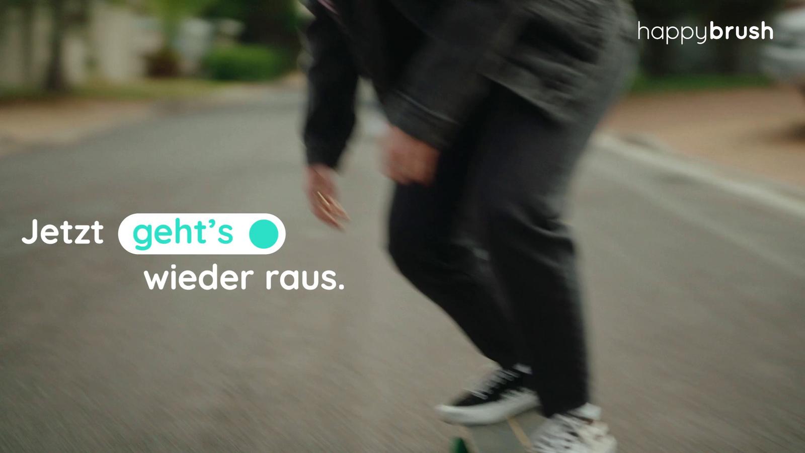 a man riding a skateboard down a street
