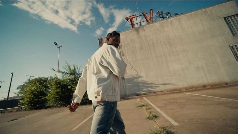 a man is walking in a parking lot