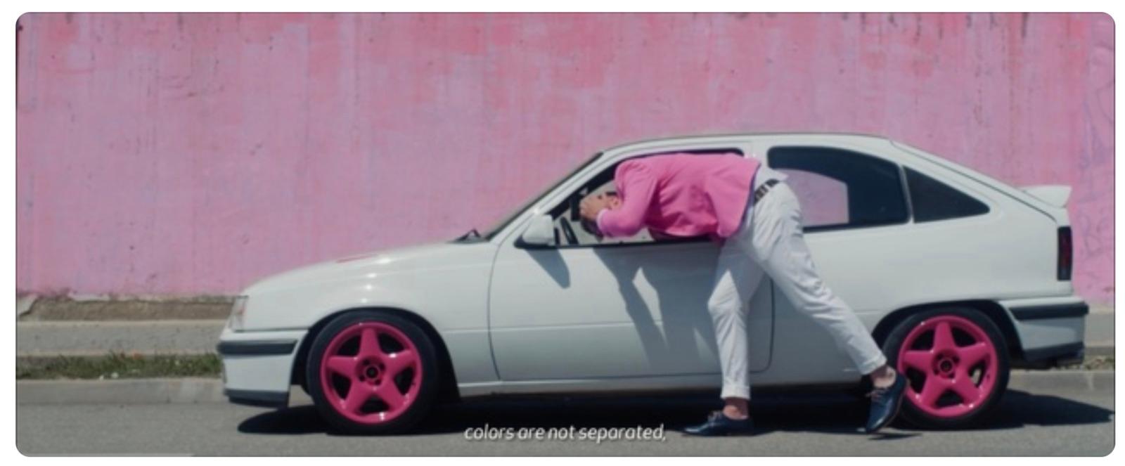 a person leaning on the hood of a car