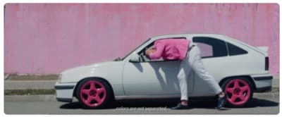 a person leaning on the hood of a car