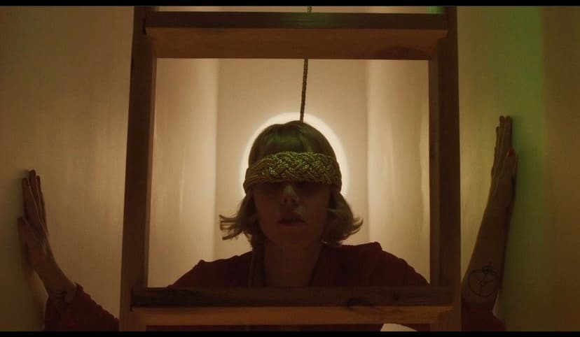 a woman with a knitted hat looking in a mirror