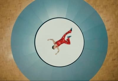 a man in a red suit is floating in a blue circle