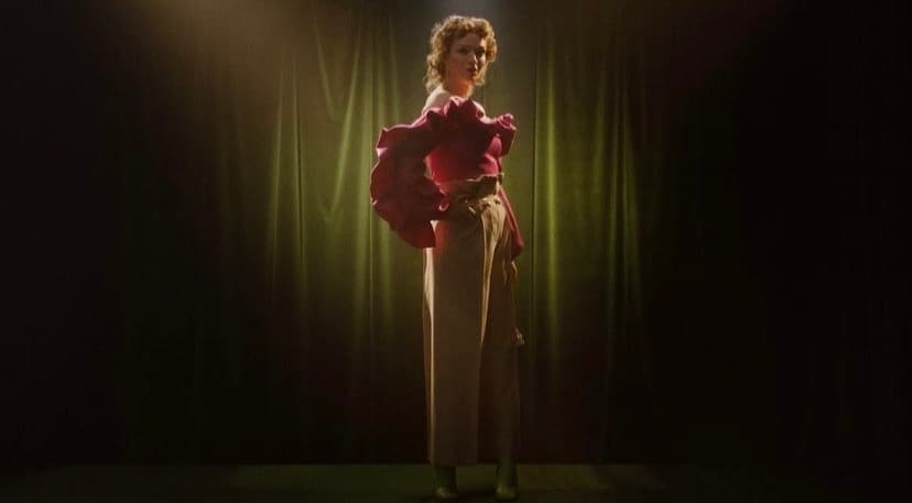 a woman standing in front of a spotlight on a stage
