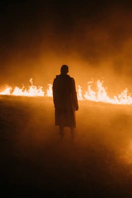 a person standing in front of a fire