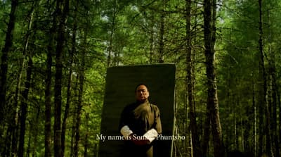 a man standing in the middle of a forest