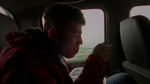 a man sitting in the back seat of a car