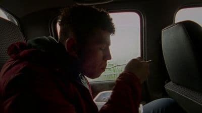 a man sitting in the back seat of a car