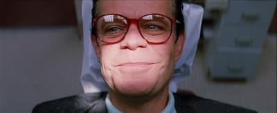 a man in a suit and tie wearing glasses