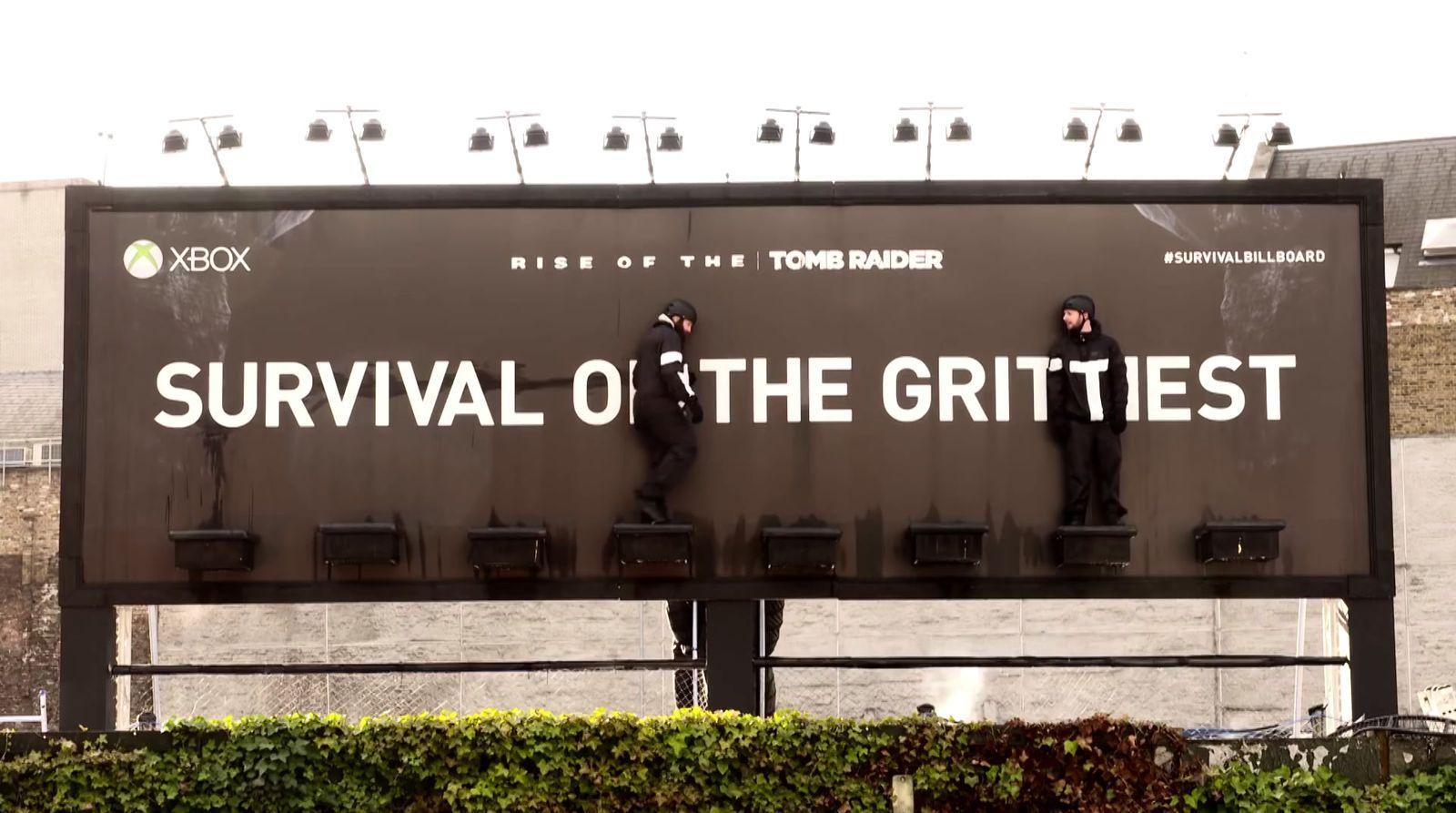a billboard with a man standing on the back of it