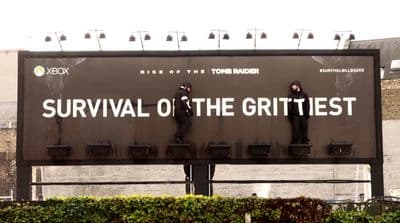 a billboard with a man standing on the back of it