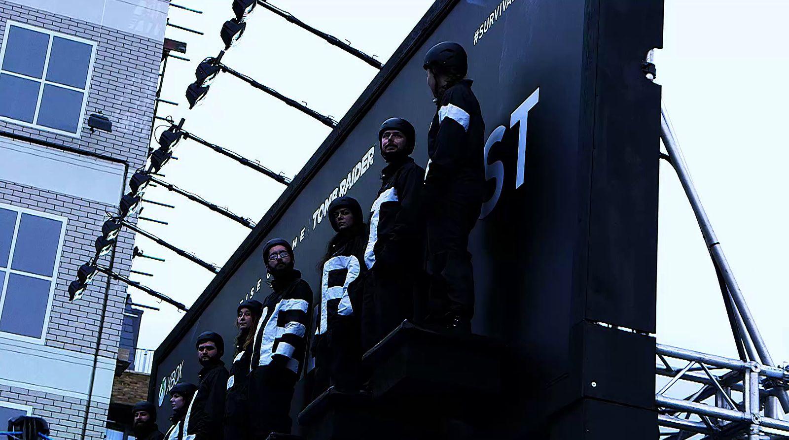 a group of people standing on top of a building