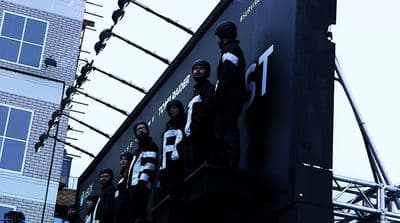 a group of people standing on top of a building