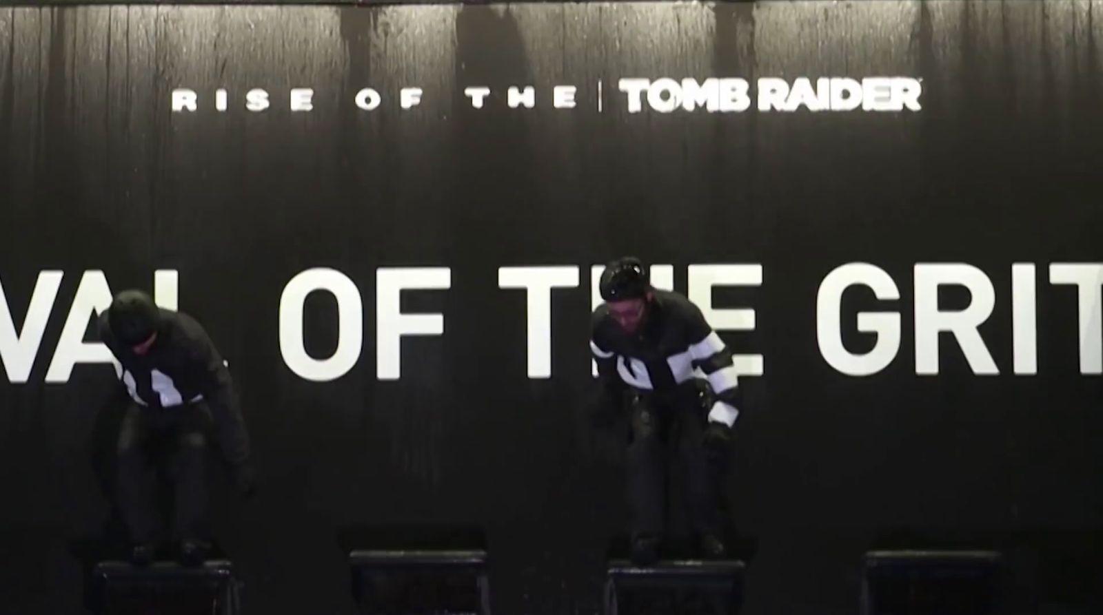 a couple of men standing on top of black stools