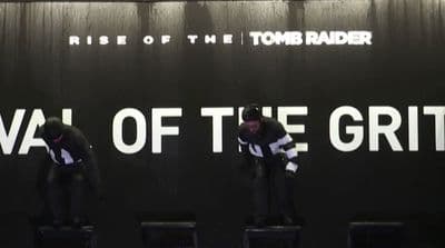 a couple of men standing on top of black stools