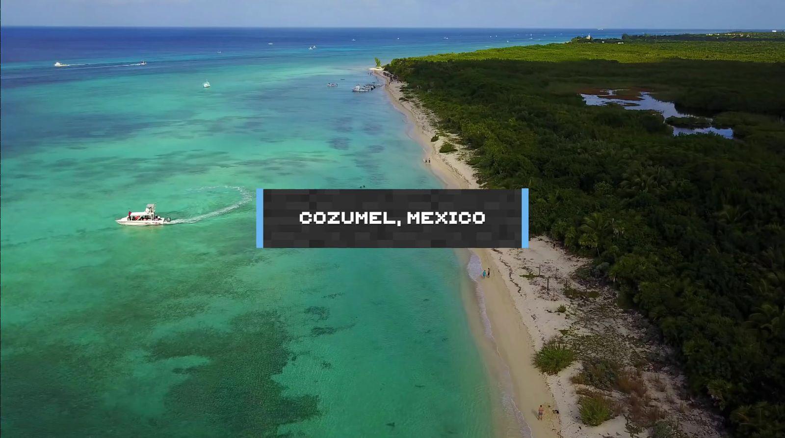 an aerial view of a beach with a boat in the water