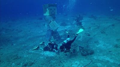 a man is standing on the bottom of a ship