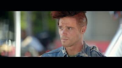 a man with red hair and a denim jacket