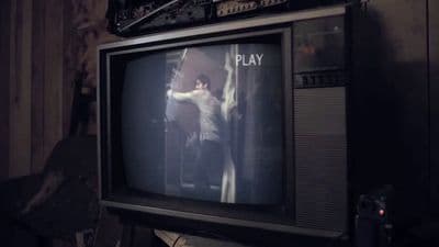 a man standing in front of a tv playing a game