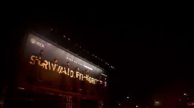 a building with a lighted sign on the side of it