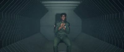 a man sitting on a chair in a tunnel