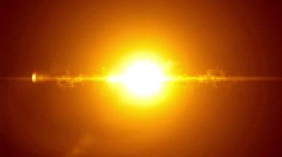 the sun is shining brightly in the dark sky