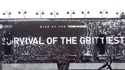 a large billboard with the words survival of the grittest on it