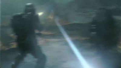a blurry image of two people walking down a street