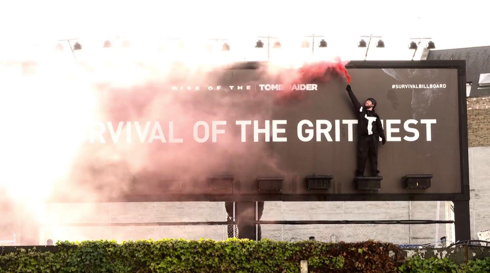 a man standing on top of a giant billboard