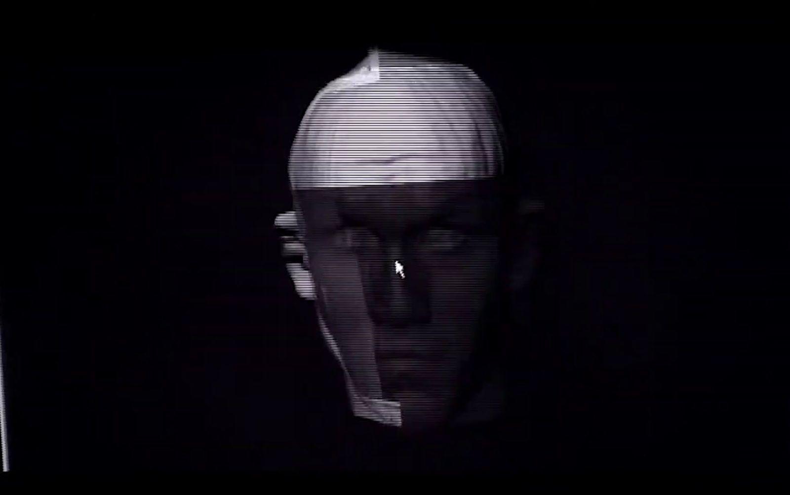 a black and white photo of a man's face in the dark